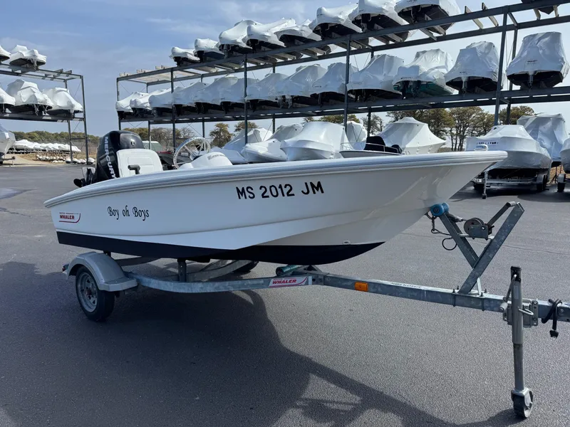 Slide: The Image of 2012 Boston Whaler 130 Super Sport boat on trailer in storage facility. - 3