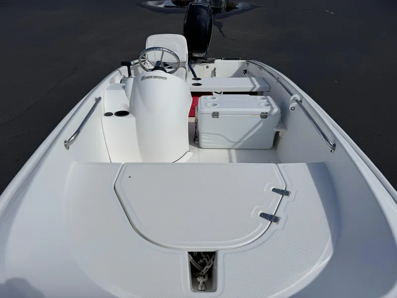 Slide: The Image of 2012 Boston Whaler 130 Super Sport boat interior with steering console and seating. - 5