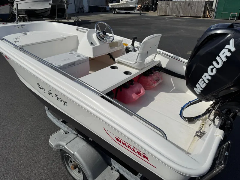 Slide: The Image of 2012 Boston Whaler 130 Super Sport boat with Mercury engine on trailer. - 7