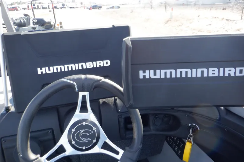 Slide: The Image of Steering wheel and Humminbird displays on 2022 Crestliner 1950 Super Hawk boat dashboard. - 12