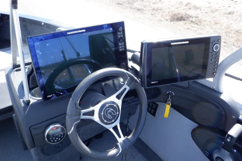 Slide: The Image of 2022 Crestliner 1950 Super Hawk dashboard with dual Humminbird displays and steering wheel. - 13
