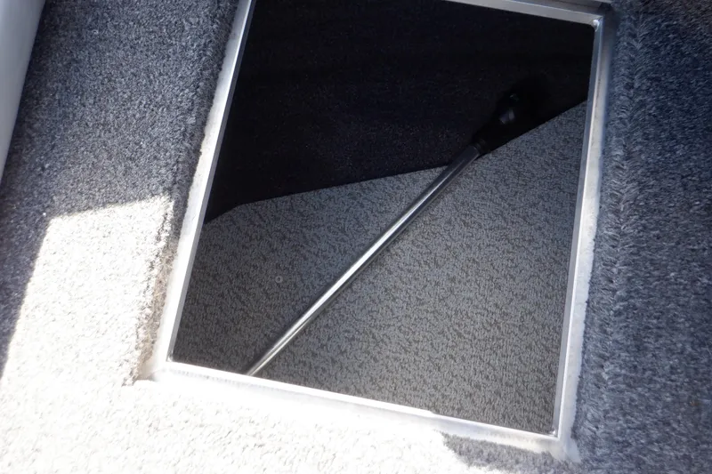 Slide: The Image of 2022 Crestliner 1950 Super Hawk storage compartment with carpeted interior and hydraulic lift support. - 23