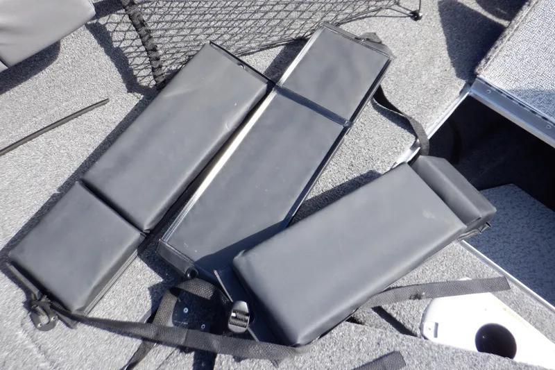 Slide: The Image of Crestliner 1950 Super Hawk 2022 boat interior with black padded seats and storage compartments. - 27