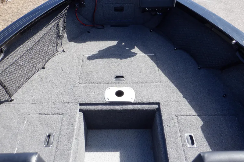 Slide: The Image of 2022 Crestliner 1950 Super Hawk boat interior with carpeted deck and storage compartments. - 29