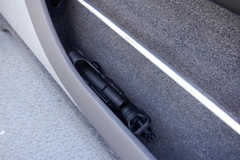 Slide: The Image of Storage compartment in 2022 Crestliner 1950 Super Hawk boat, featuring a neatly stored black accessory. - 37