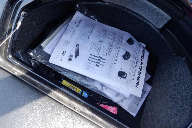 Slide: The Image of Storage compartment of 2022 Crestliner 1950 Super Hawk with manuals and documents. - 45