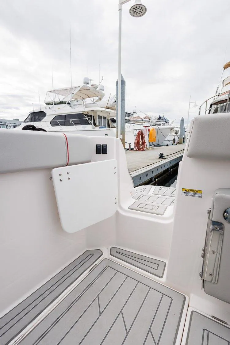Slide: The Image of 2026 Solara S-250 Coupe boat interior at marina, featuring sleek design and modern amenities. - 25
