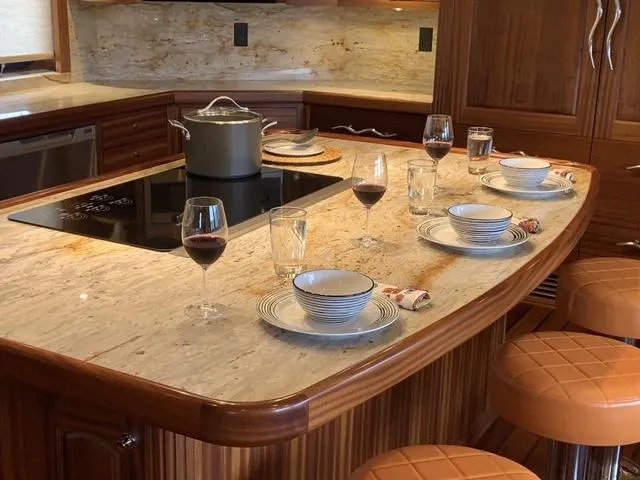 Slide: The Image of Luxurious yacht kitchen with marble countertop, set for dining, featuring Allseas Expedition model, 2018. - 26