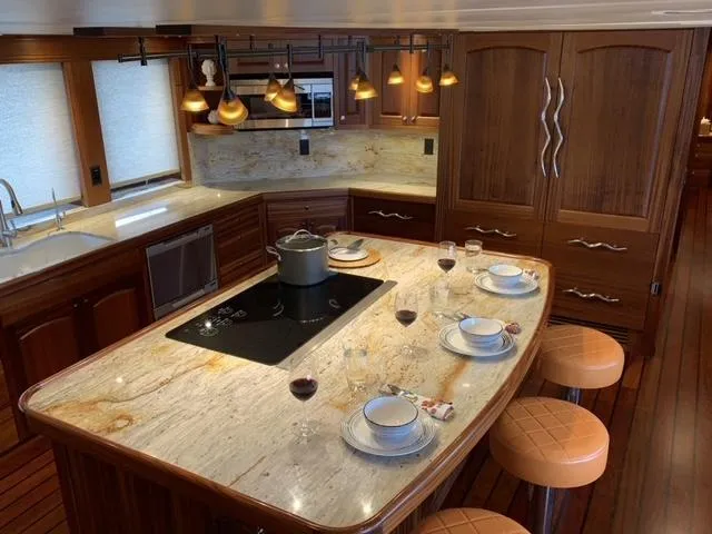 Slide: The Image of Luxurious yacht kitchen with marble island, elegant lighting, and modern appliances, Allseas Expedition 2018. - 27