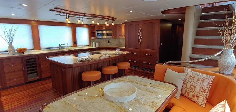 Slide: The Image of Luxurious 2018 Allseas Expedition yacht interior with modern kitchen, dining area, and elegant wood finishes. - 30