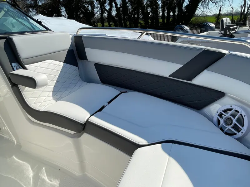 Slide: The Image of 2025 Chaparral 267 SSX boat interior with stylish seating and speaker. - 11
