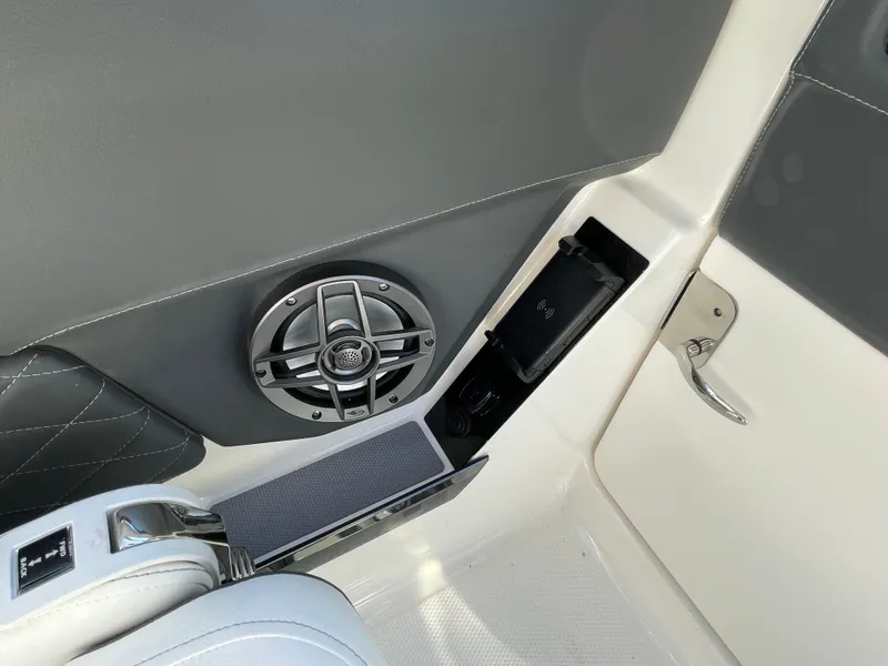 Slide: The Image of Interior of 2025 Chaparral 267 SSX boat featuring speaker and storage compartment. - 24