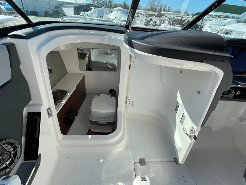Slide: The Image of 2025 Chaparral 267 SSX boat interior with compact cabin and modern amenities. - 27