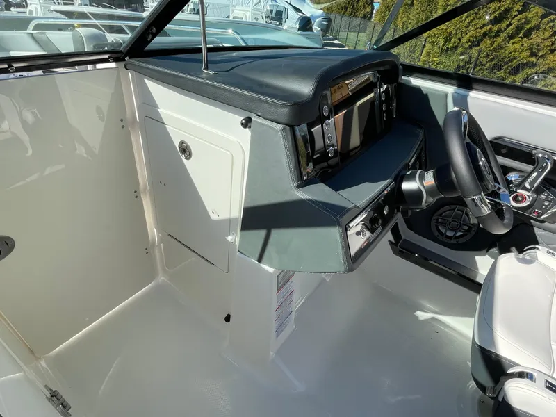 Slide: The Image of 2025 Chaparral 267 SSX boat cockpit with modern steering and control panel. - 30