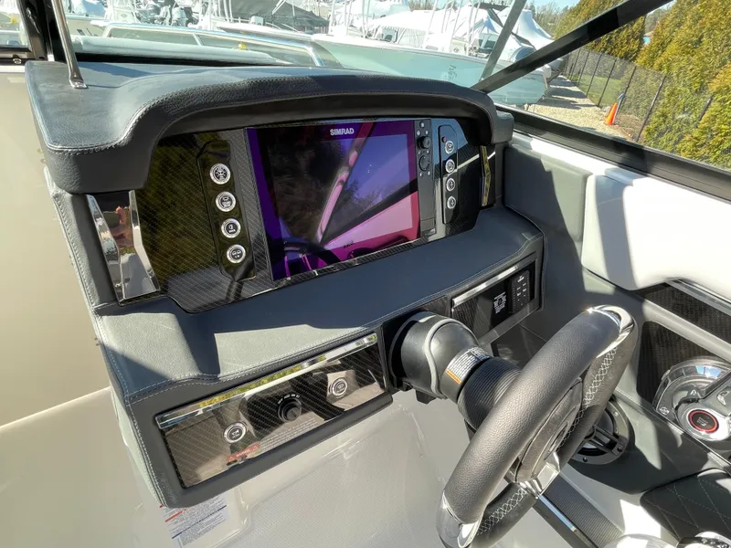 Slide: The Image of 2025 Chaparral 267 SSX dashboard with advanced navigation system and steering wheel. - 32