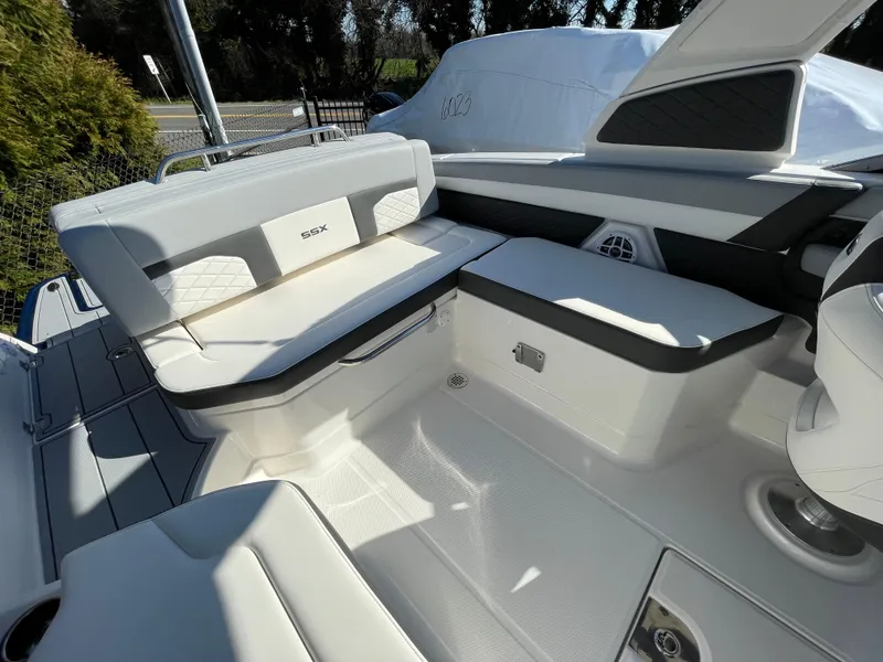 Slide: The Image of 2025 Chaparral 267 SSX boat interior with sleek white seating and modern design. - 46