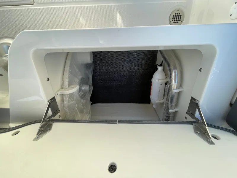 Slide: The Image of 2025 Chaparral 267 SSX storage compartment with safety equipment and sleek design. - 47