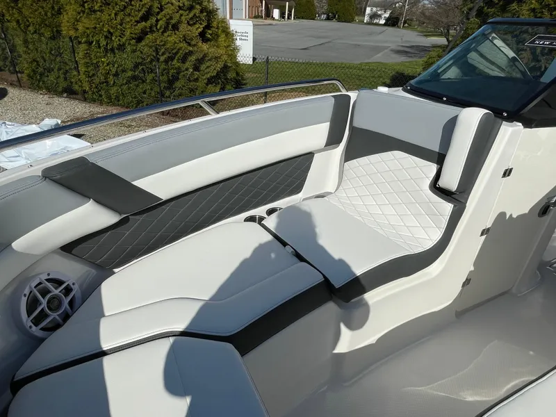 Slide: The Image of 2025 Chaparral 267 SSX boat interior with sleek white and gray seating design. - 14