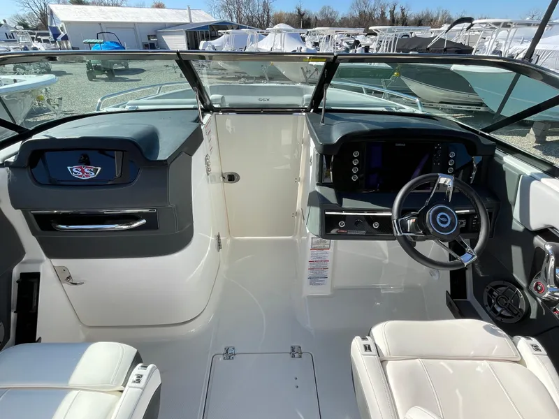 Slide: The Image of 2025 Chaparral 267 SSX boat cockpit with modern steering and dashboard controls. - 20