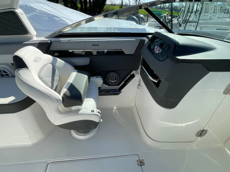 Slide: The Image of 2025 Chaparral 267 SSX boat interior with modern helm and comfortable seating. - 26
