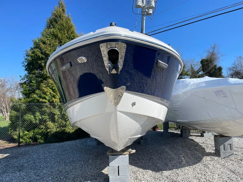 Slide: The Image of 2025 Chaparral 267 SSX boat on display, front view, outdoors. - 3