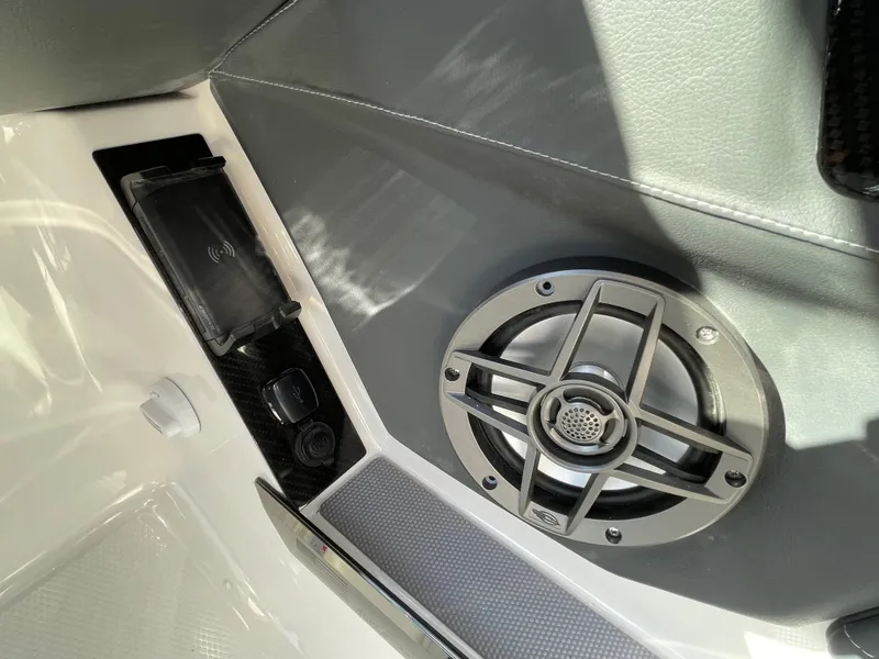 Slide: The Image of 2025 Chaparral 267 SSX boat interior with speaker and phone charging dock. - 38