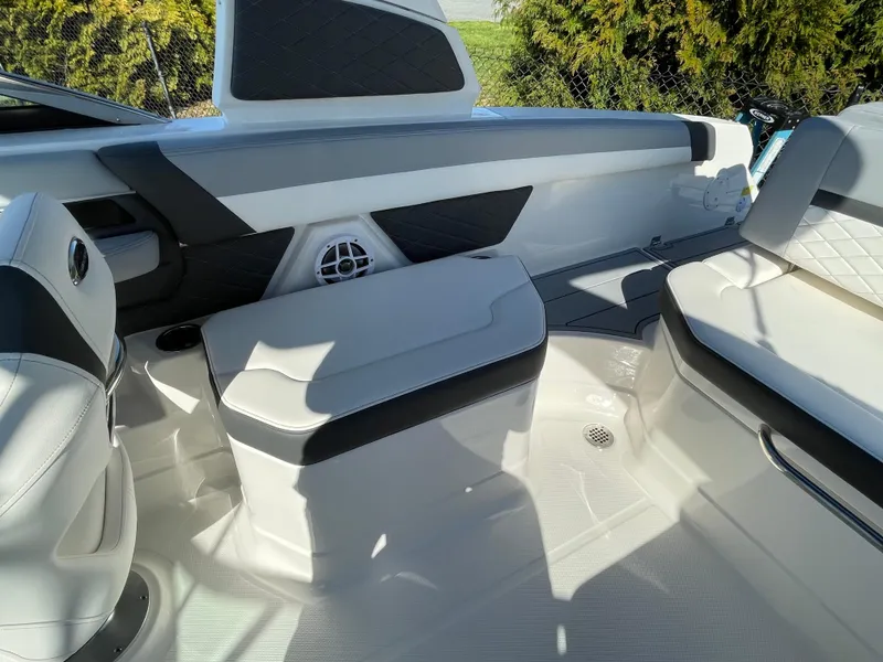 Slide: The Image of 2025 Chaparral 267 SSX boat interior with sleek white seating and modern design elements. - 40