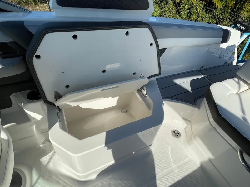 Slide: The Image of 2025 Chaparral 267 SSX boat interior with open storage compartment. - 42