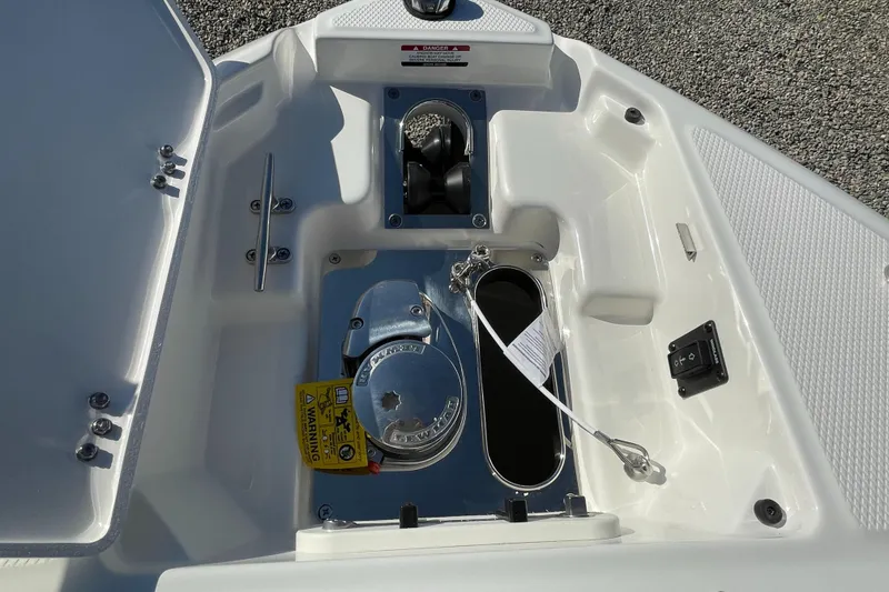 Slide: The Image of 2025 Chaparral 267 SSX boat anchor compartment with winch and storage features. - 9