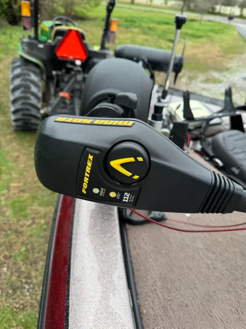 Slide: The Image of 2012 Skeeter ZX 21 boat with Fortrex trolling motor, parked near a tractor. - 10