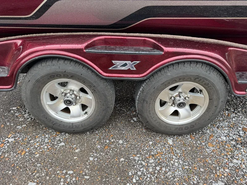 Slide: The Image of 2012 Skeeter ZX 21 trailer with dual wheels on gravel surface. - 11