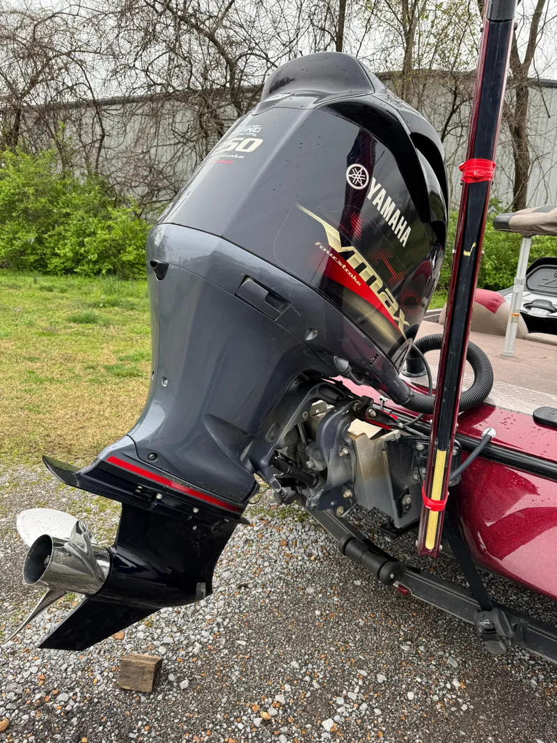 Slide: The Image of 2012 Skeeter ZX 21 with Yamaha outboard motor, parked on gravel. - 12