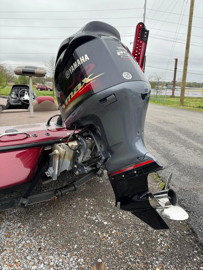 Slide: The Image of 2012 Skeeter ZX 21 boat with Yamaha outboard motor, parked on gravel. - 13