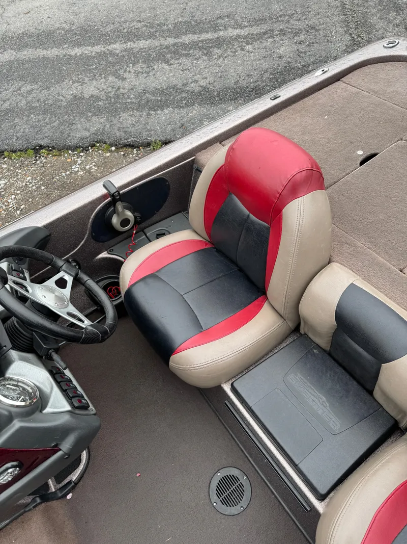 Slide: The Image of 2012 Skeeter ZX 21 boat interior with red and black seating and steering wheel. - 3