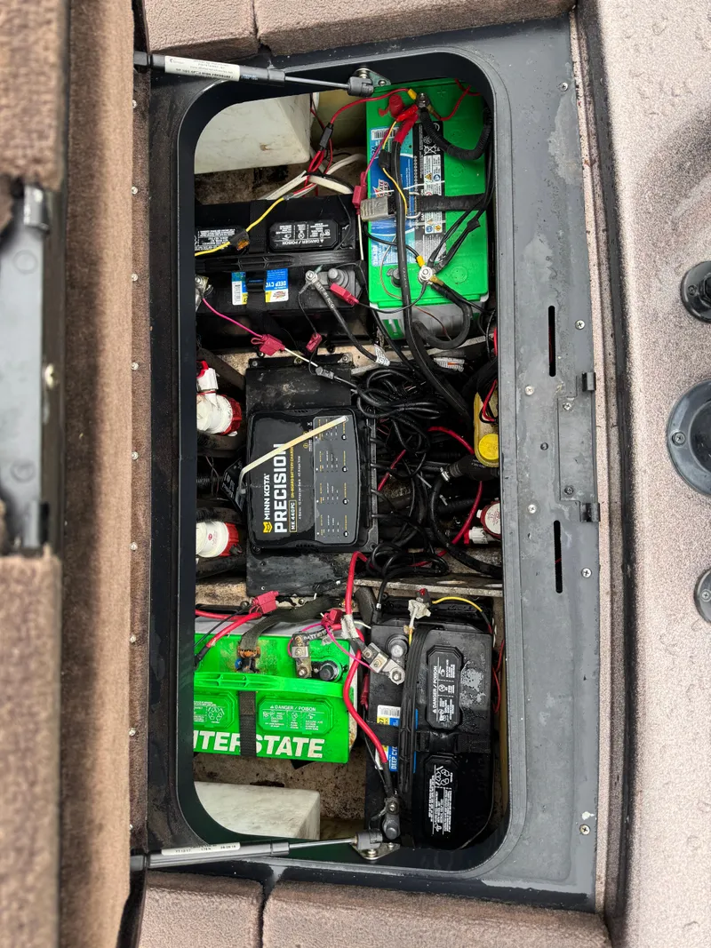 Slide: The Image of Battery compartment of a 2012 Skeeter ZX 21 boat with multiple batteries and wiring. - 8