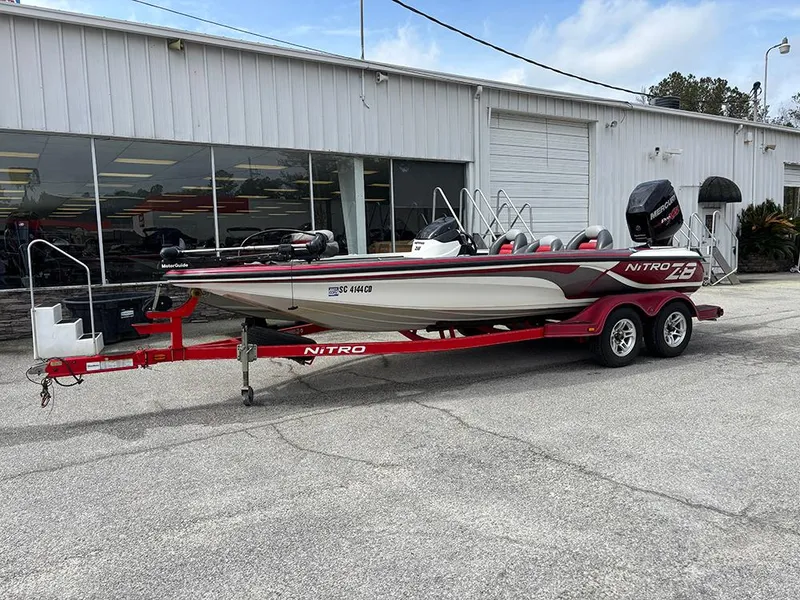 Slide: The Image of 2011 Nitro Z-8 boat on red trailer parked outside a building. - 0