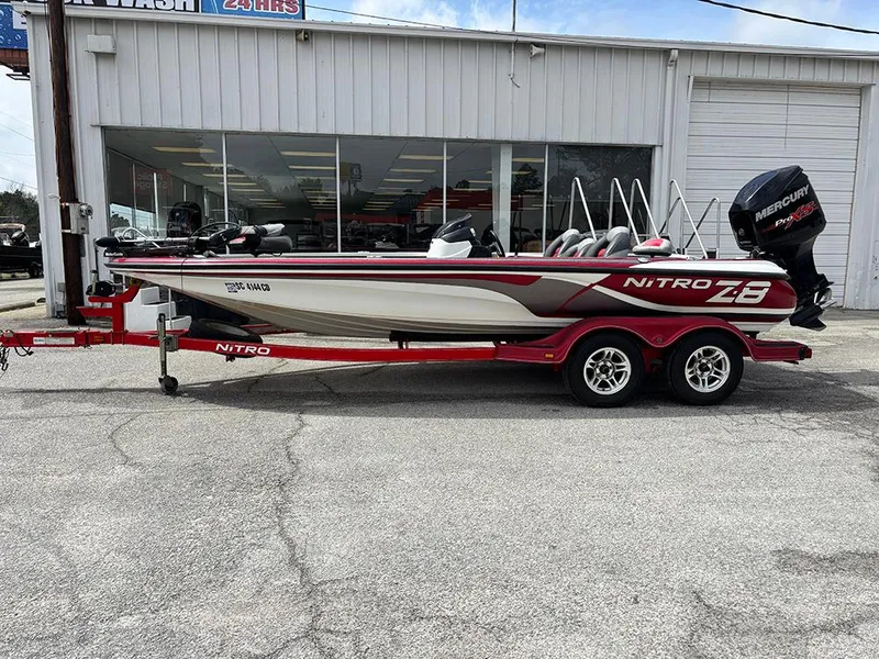 Slide: The Image of 2011 Nitro Z-8 boat with trailer, parked outside a building. - 1