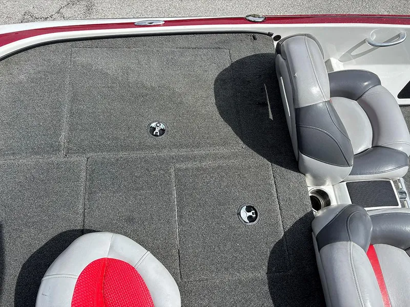 Slide: The Image of 2011 Nitro Z-8 boat interior with gray and red seating and carpeted flooring. - 17