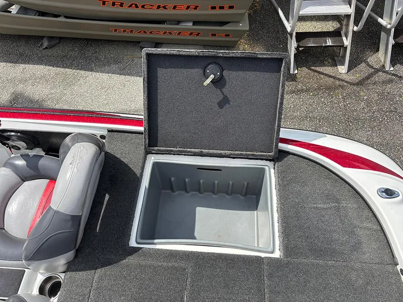 Slide: The Image of Open storage compartment on 2011 Nitro Z-8 boat deck with key in lock. - 18