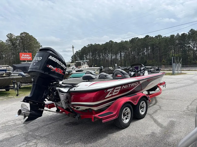 Slide: The Image of 2011 Nitro Z-8 boat with Mercury engine on a trailer in a parking lot. - 6