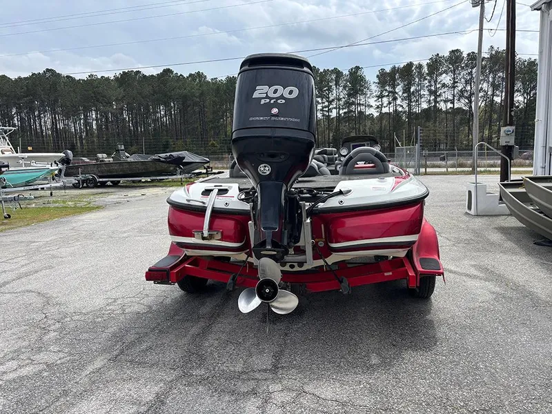 Slide: The Image of Red 2011 Nitro Z-8 boat with 200 Pro outboard motor, parked outdoors. - 7