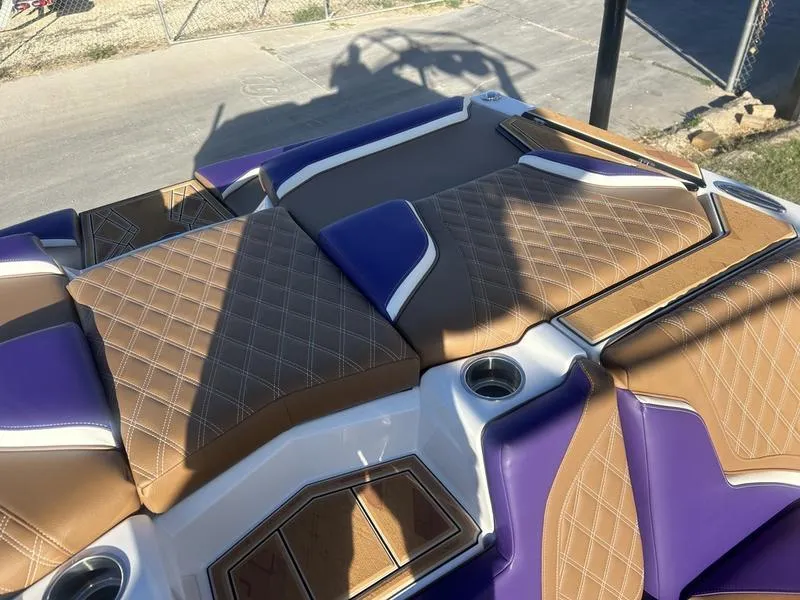 Slide: The Image of 2025 Tigé 24RZX boat interior with purple and brown diamond-stitched upholstery. - 2