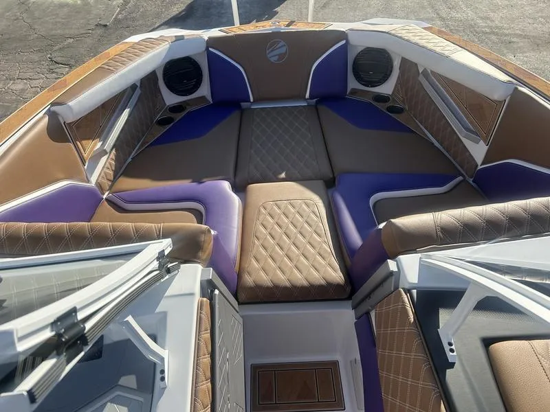 Slide: The Image of 2025 Tigé 24RZX boat interior with luxurious brown and purple seating. - 3