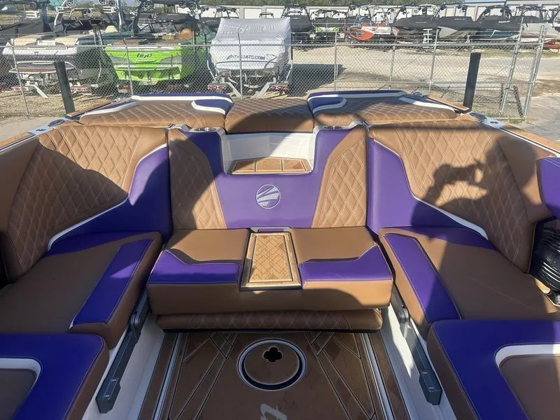Slide: The Image of 2025 Tigé 24RZX boat interior with brown and purple seating, diamond stitching. - 4