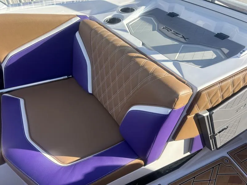 Slide: The Image of 2025 Tigé 24RZX boat interior with purple and brown seating, featuring diamond stitching. - 5