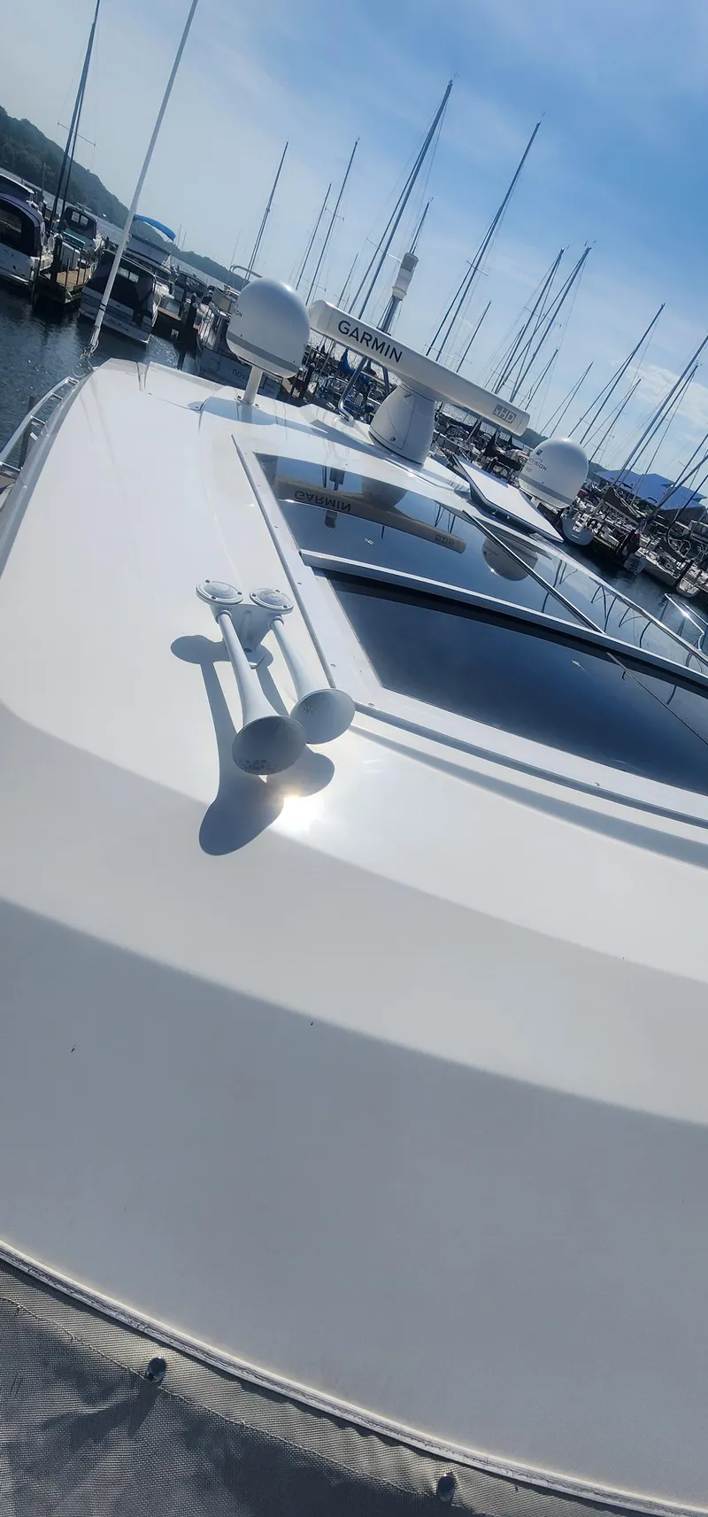 Slide: The Image of 2014 Cruisers Cantius yacht with Garmin radar, docked in a marina under clear skies. - 14
