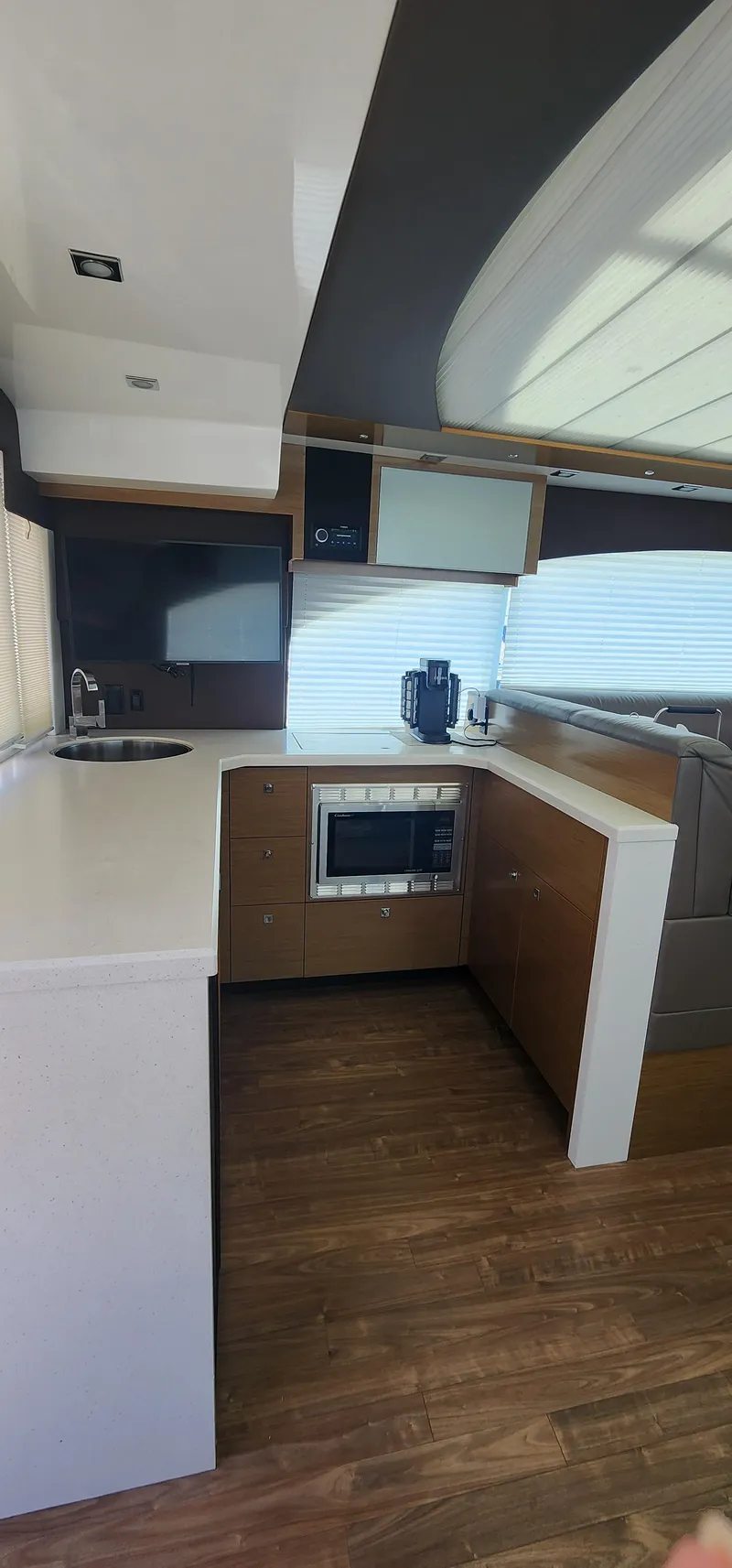 Slide: The Image of 2014 Cruisers Cantius yacht kitchen with modern appliances and wood flooring. - 23
