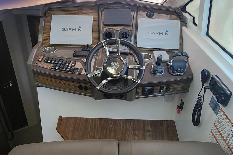 Slide: The Image of 2014 Cruisers Cantius helm with Garmin navigation, steering wheel, and control panel. - 24