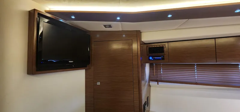 Slide: The Image of Interior of 2014 Cruisers Cantius yacht with TV, wood paneling, and blinds. - 35