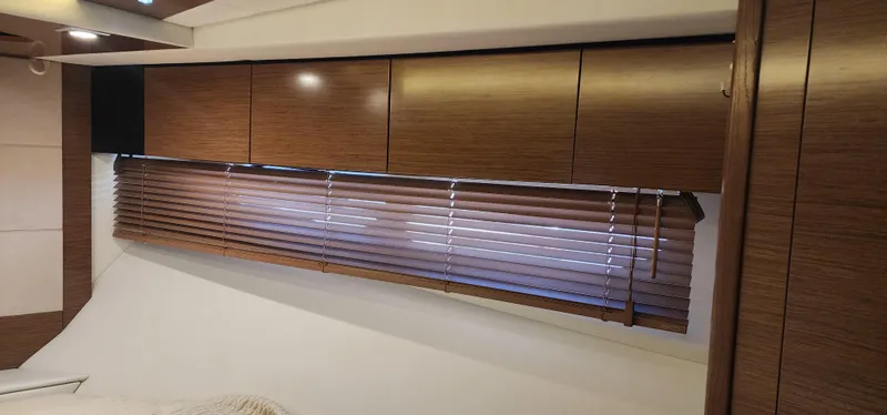 Slide: The Image of 2014 Cruisers Cantius interior with wooden cabinets and blinds. - 44